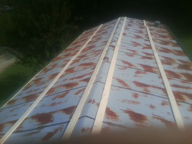 Rusted metal roof panels with new wood purlins before replacement — Storm Damage Roof Repair in Antelope by Roofing Brothers