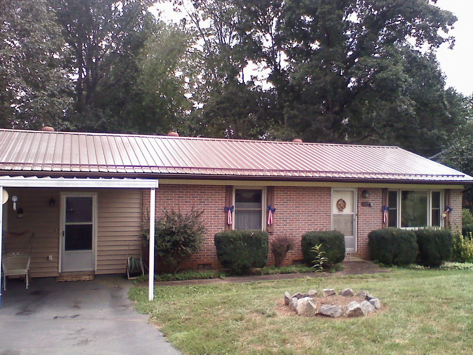 Bronze metal roof and carport on a brick ranch home — Roof Repair work by our crew in Antelope